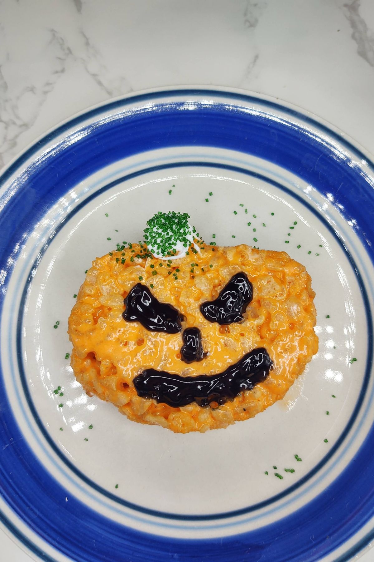 Pumpkin rice krispie treat on a plate.