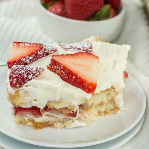 Slice of strawberry tiramisu on a white plate.