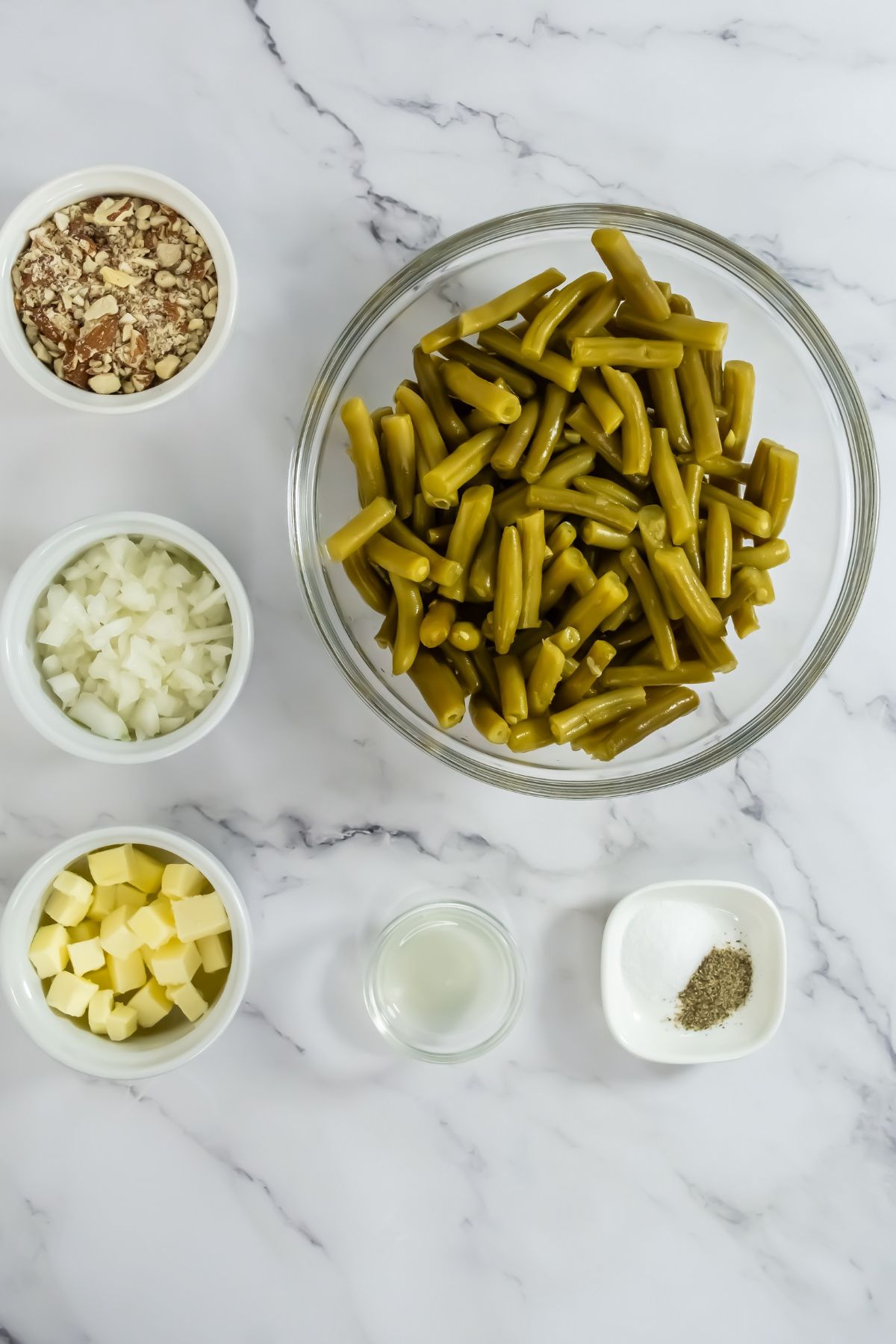 Canned green bean ingredients on a marble counter.