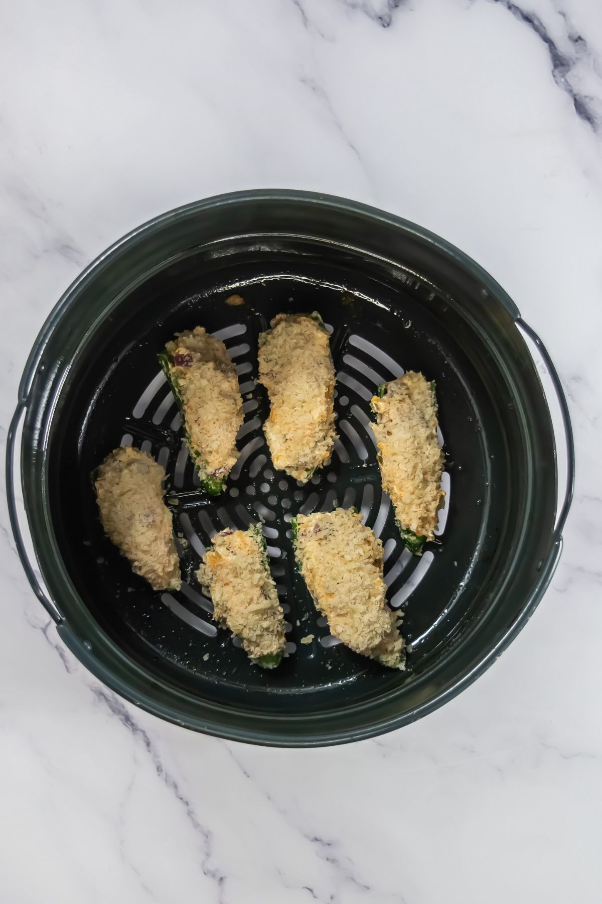 Jalapeno poppers in an air fryer.