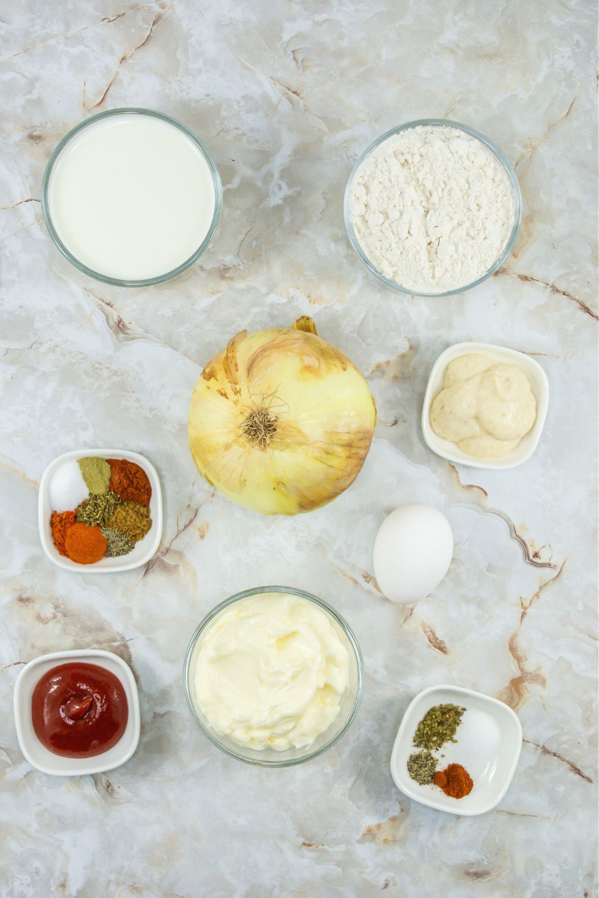 Air fryer blooming onion ingredients on a marble counter.