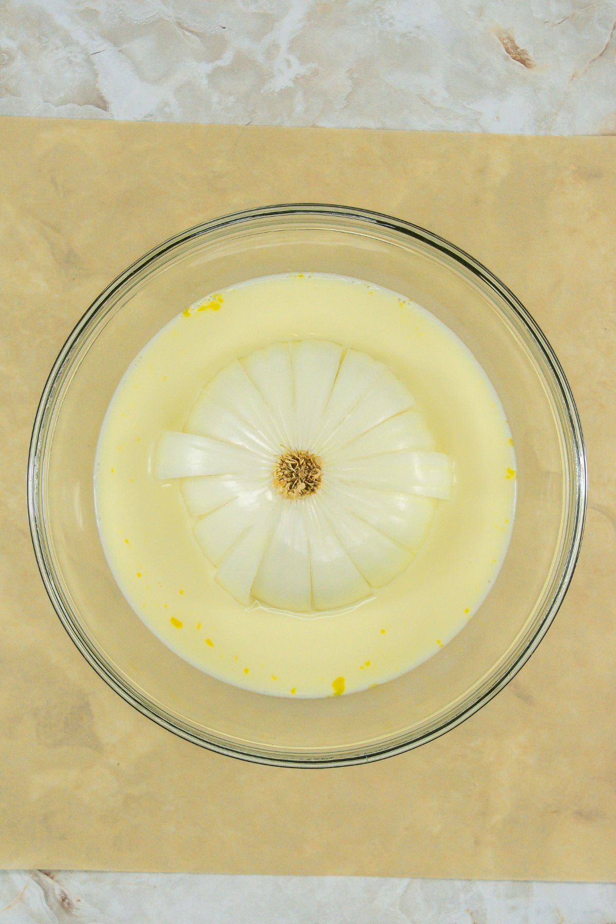 Sliced onion in wet ingredients.