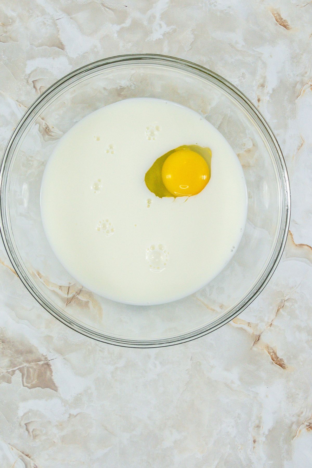 Egg and milk in mixing bowl.