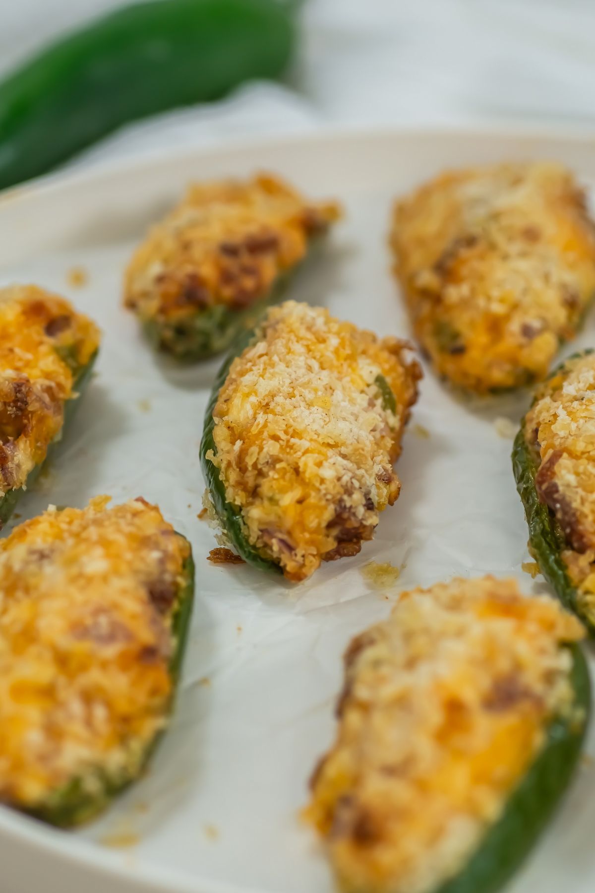 Air fryer jalapeno poppers on a white plate.