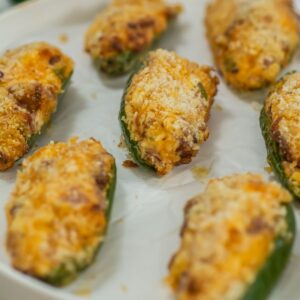 Air fryer jalapeno poppers on a white plate.