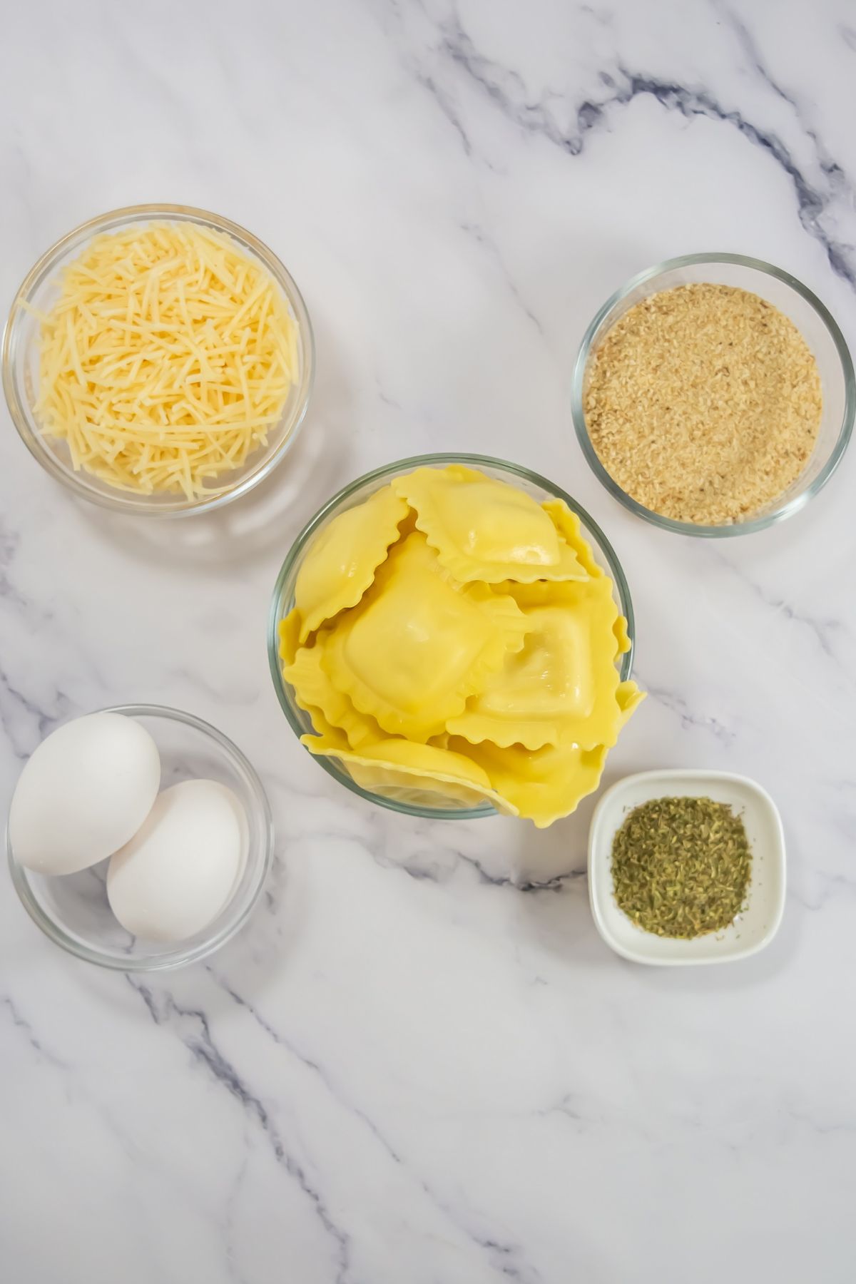 Air fryer ravioli ingredients on a marble counter.
