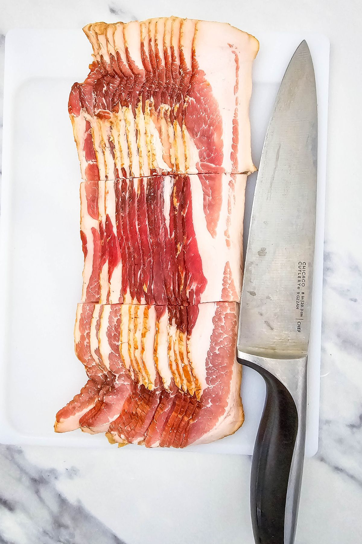 Bacon sliced on cutting board.
