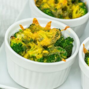 Broccoli cheese casserole in white ramekins.