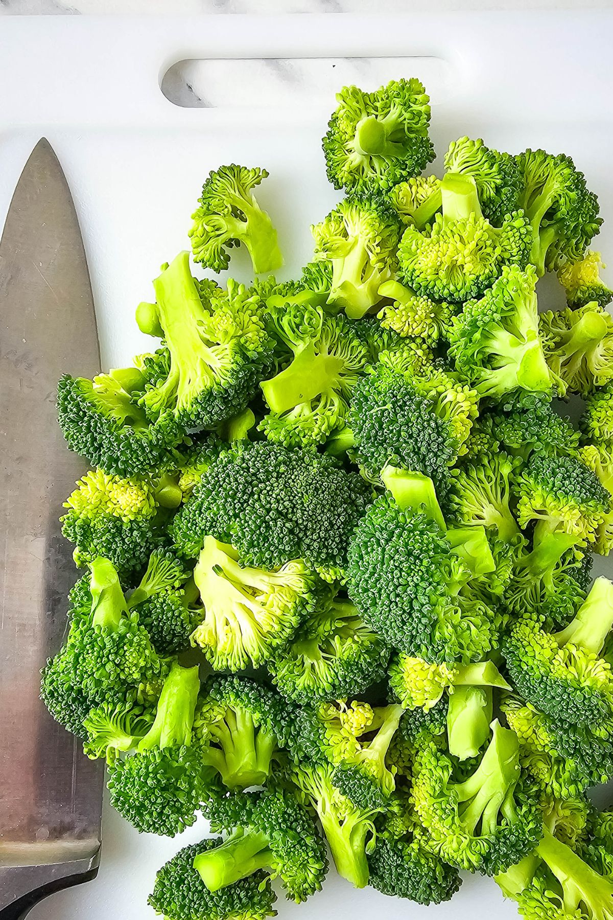 Chopped broccoli on a cutting board.