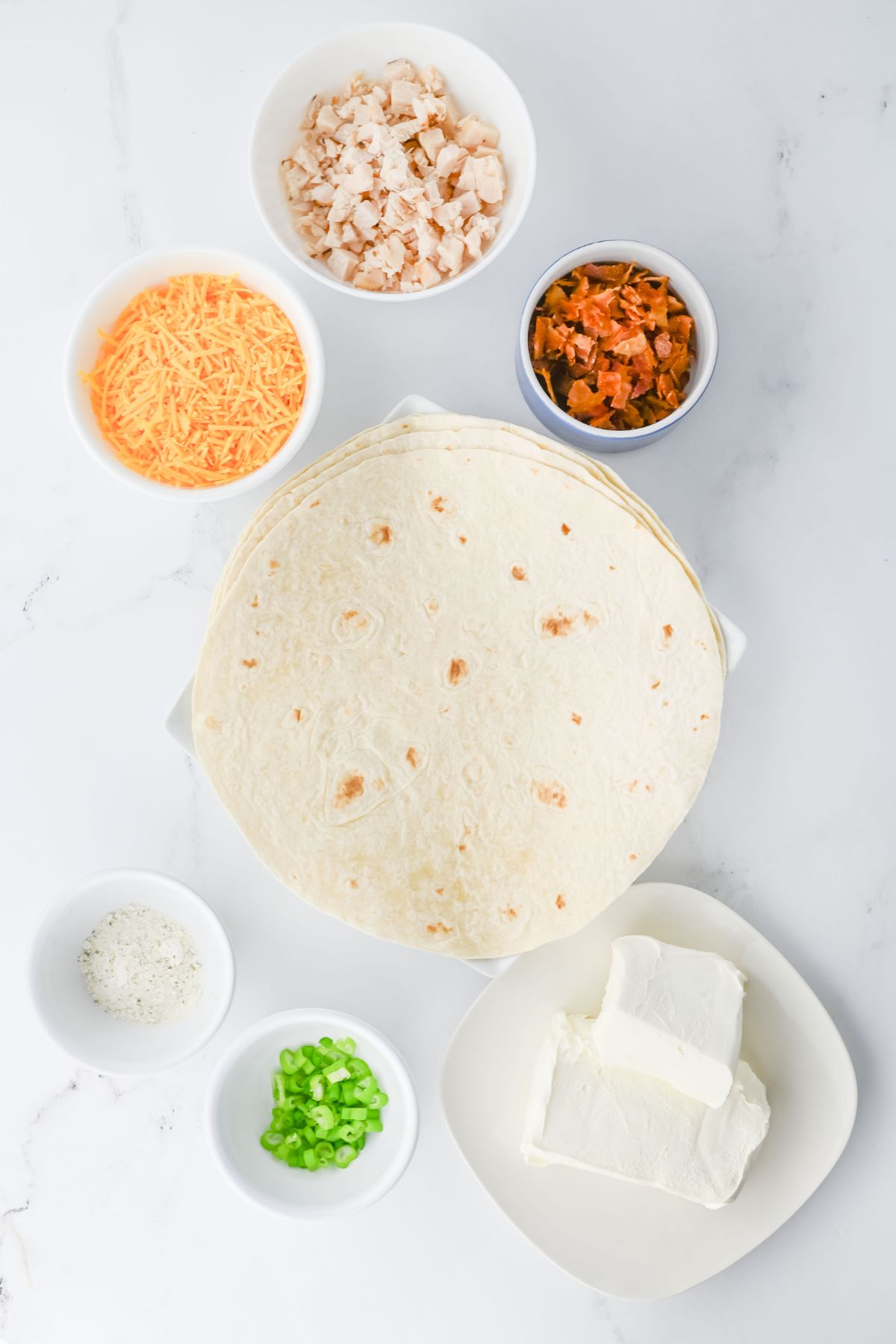 Chicken crack rollup ingredients on a white table.