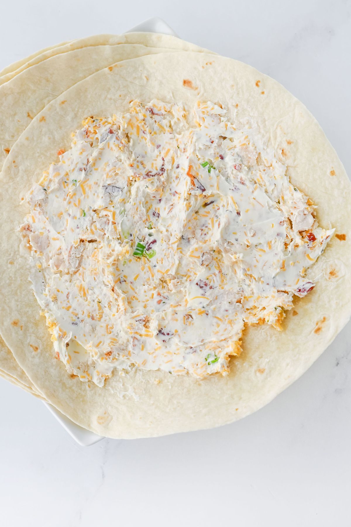 Chicken mixture spread on tortillas.