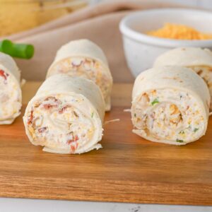Chicken crack rollups cut on a wooden table.