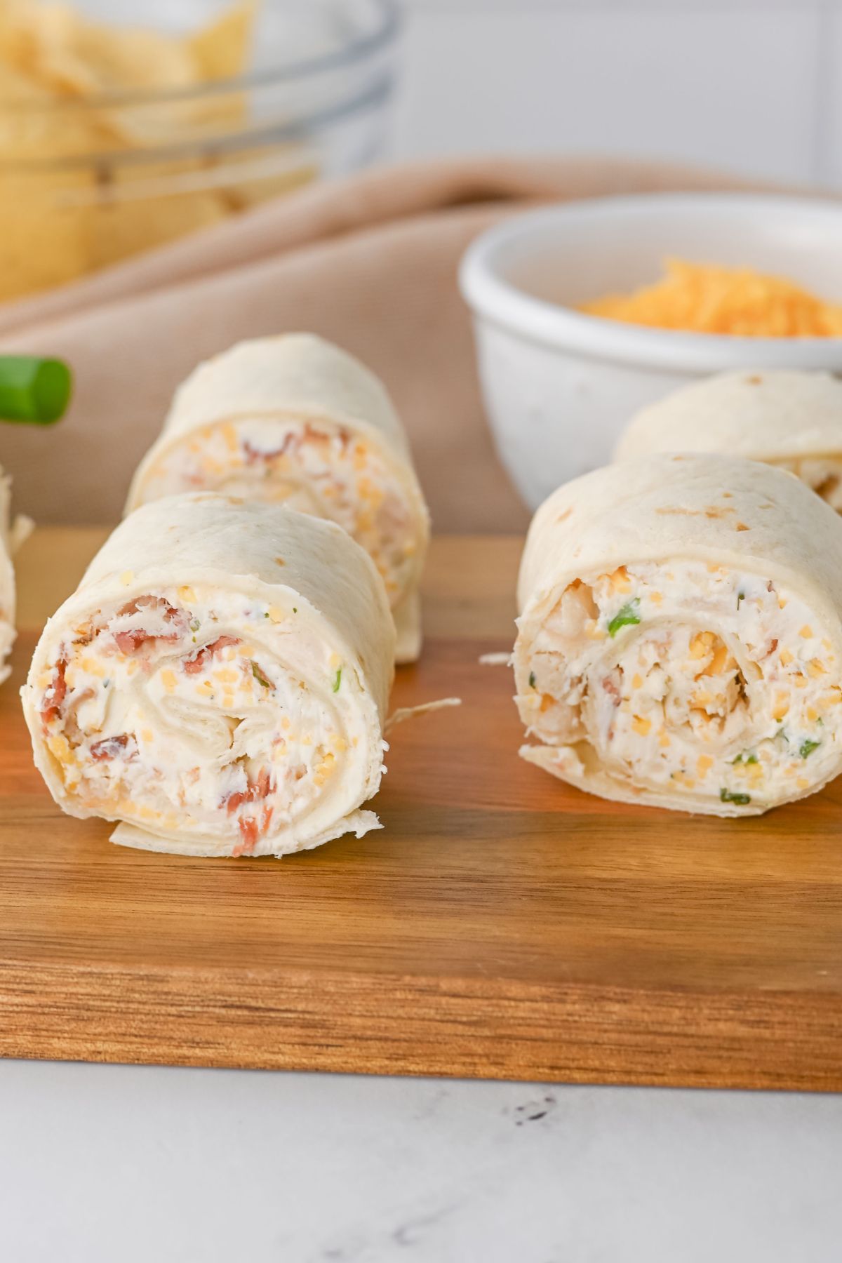 Chicken crack rollups cut on a wooden table.
