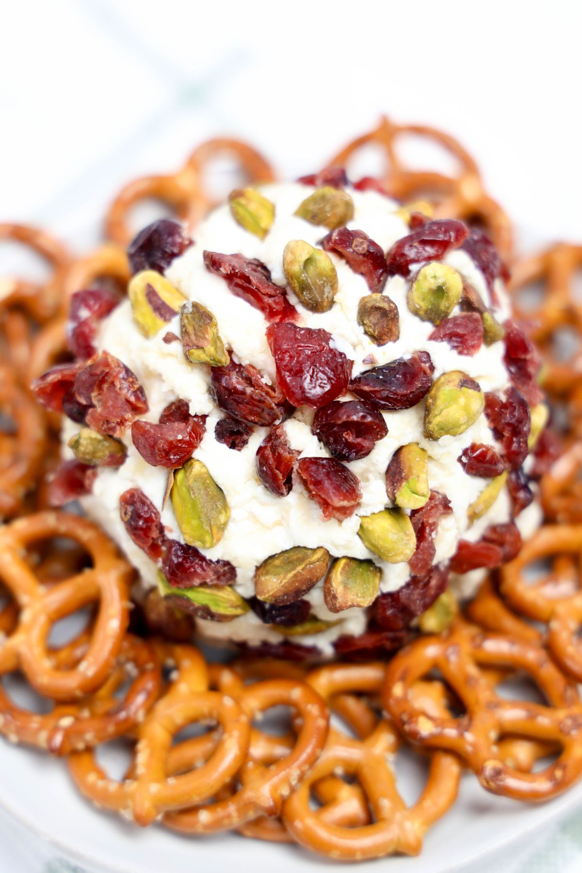 Cranberry parmesan cheeseball surrounded by pretzels.