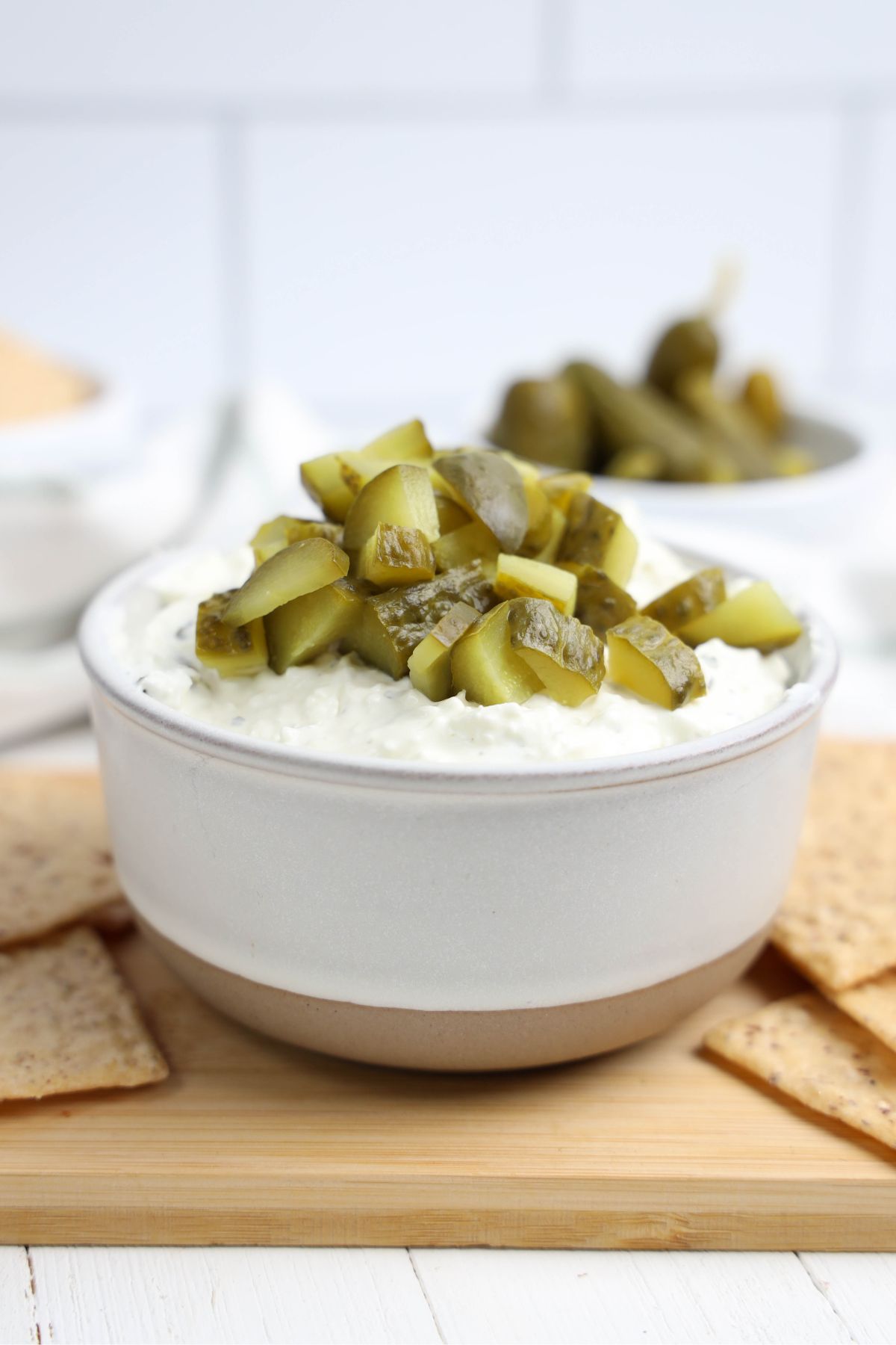 Dill pickle dip on a wooden surface.