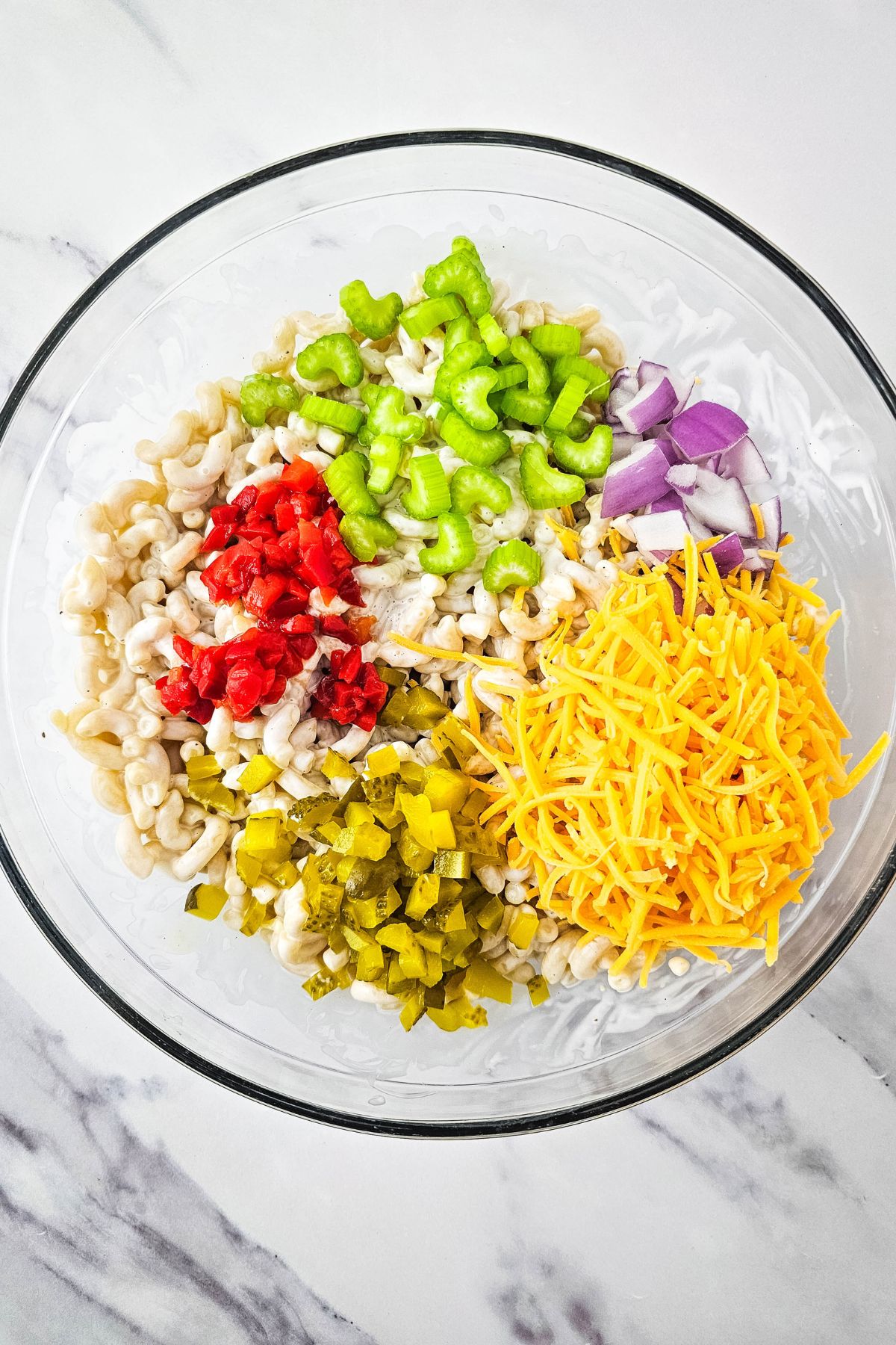 Chopped veggies and cheese in a bowl.