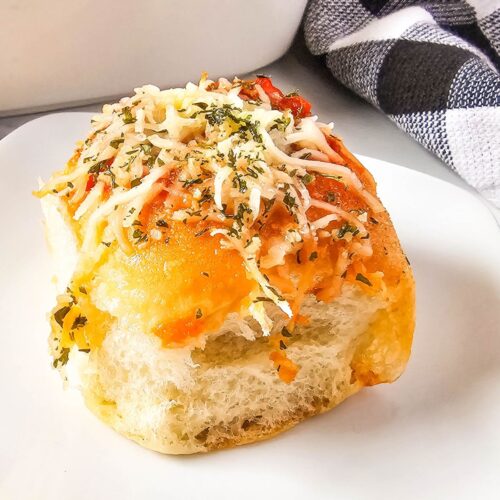 Meatball slider on a white plate.