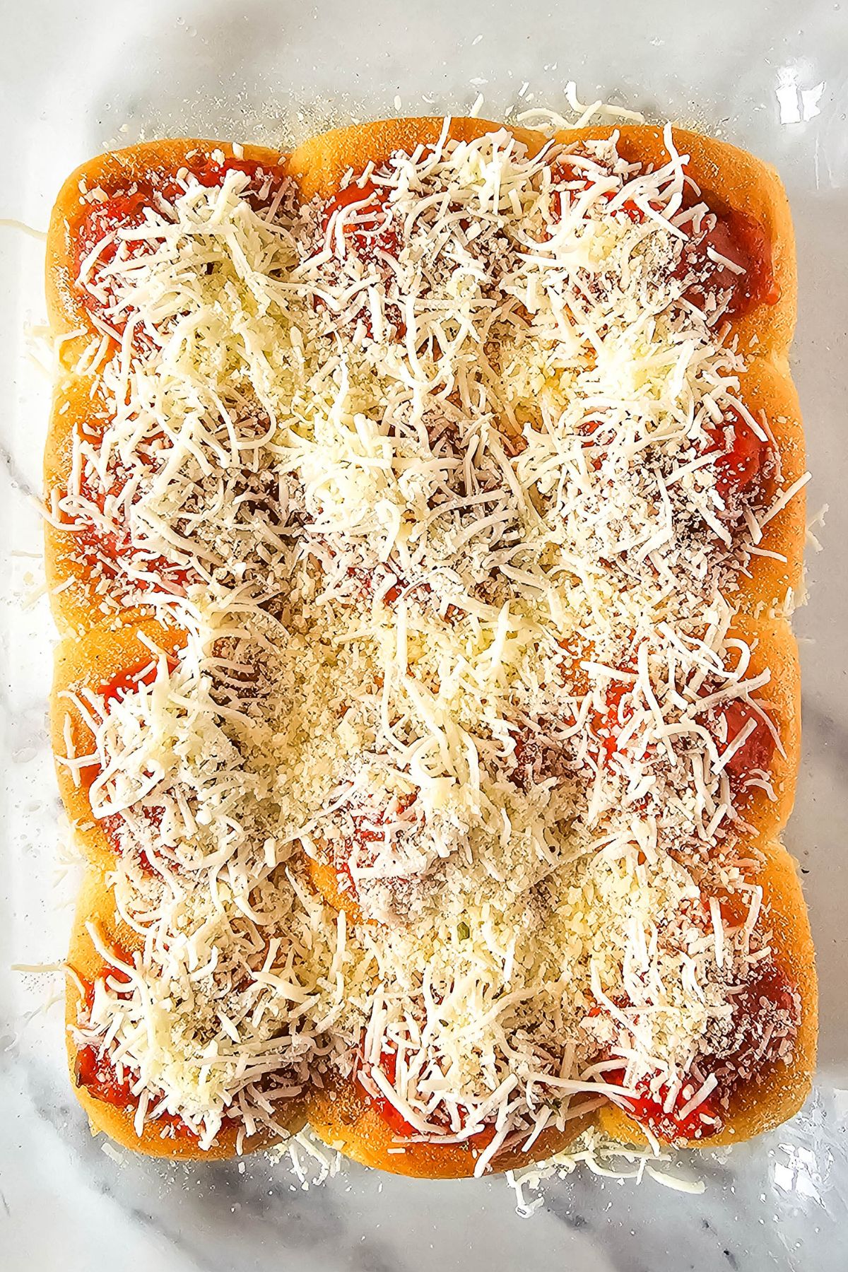 Cheese on top of sliders.