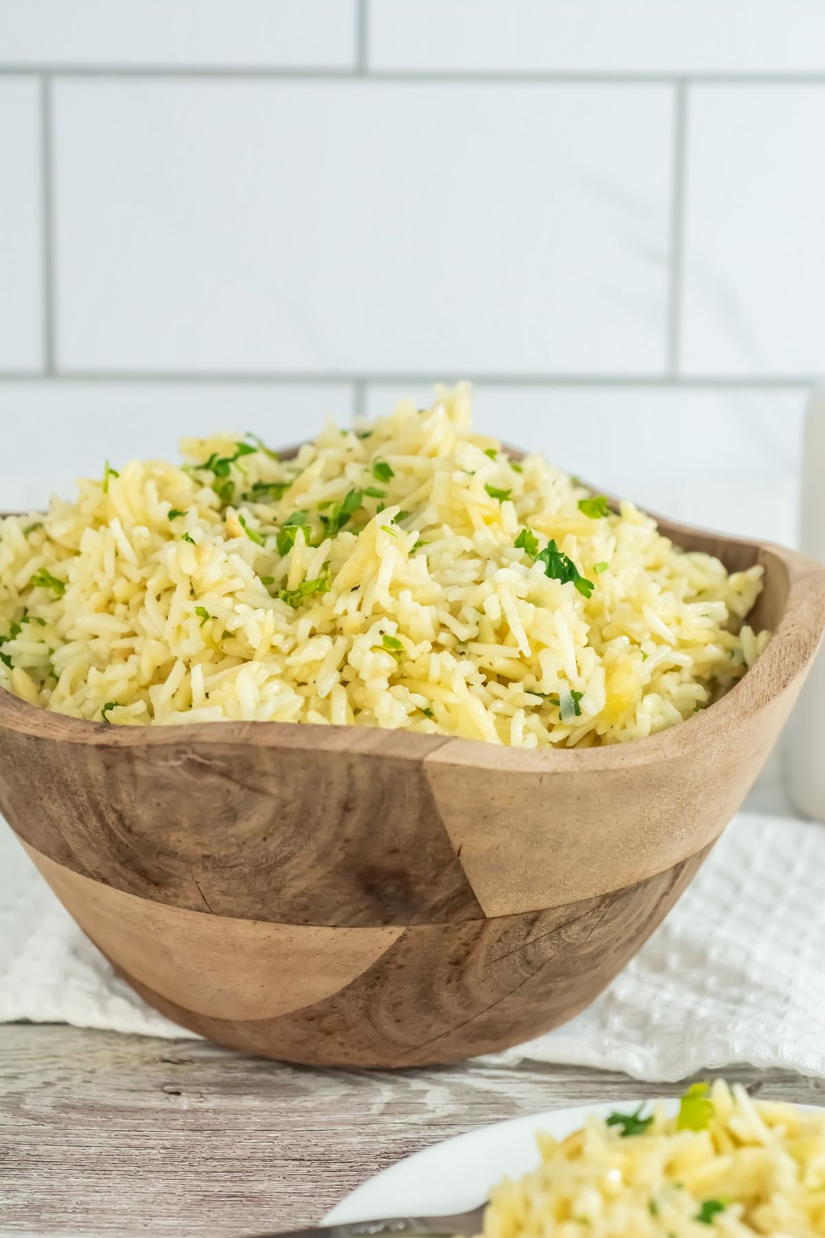 Orzo rice pilaf in a wooden bowl.