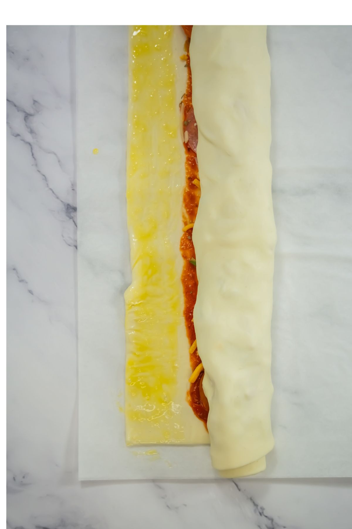 Butter on one piece of a rolled puff pastry.