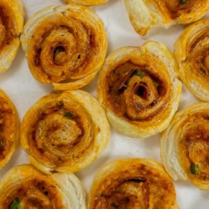 Pizza pinwheels on a white surface.