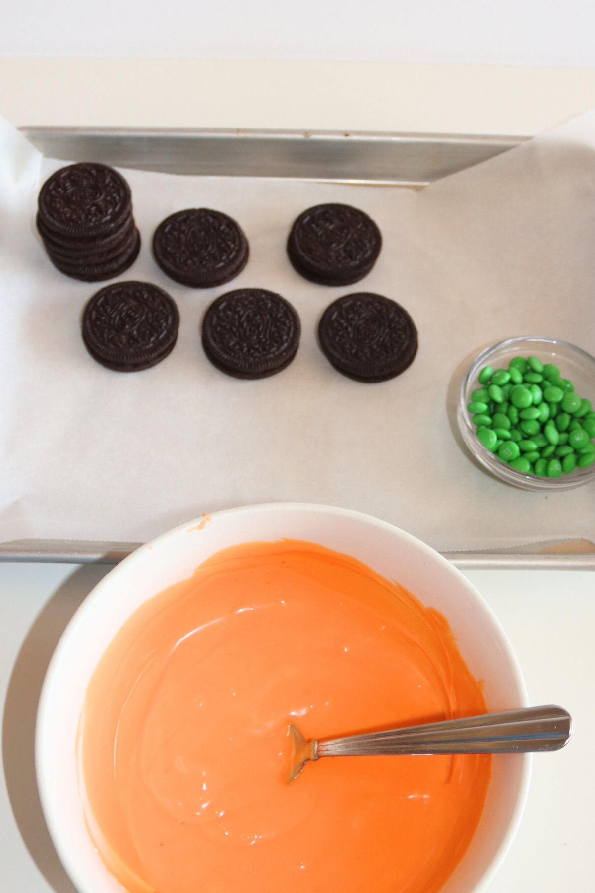 Melted orange candy wafers in a bowl.