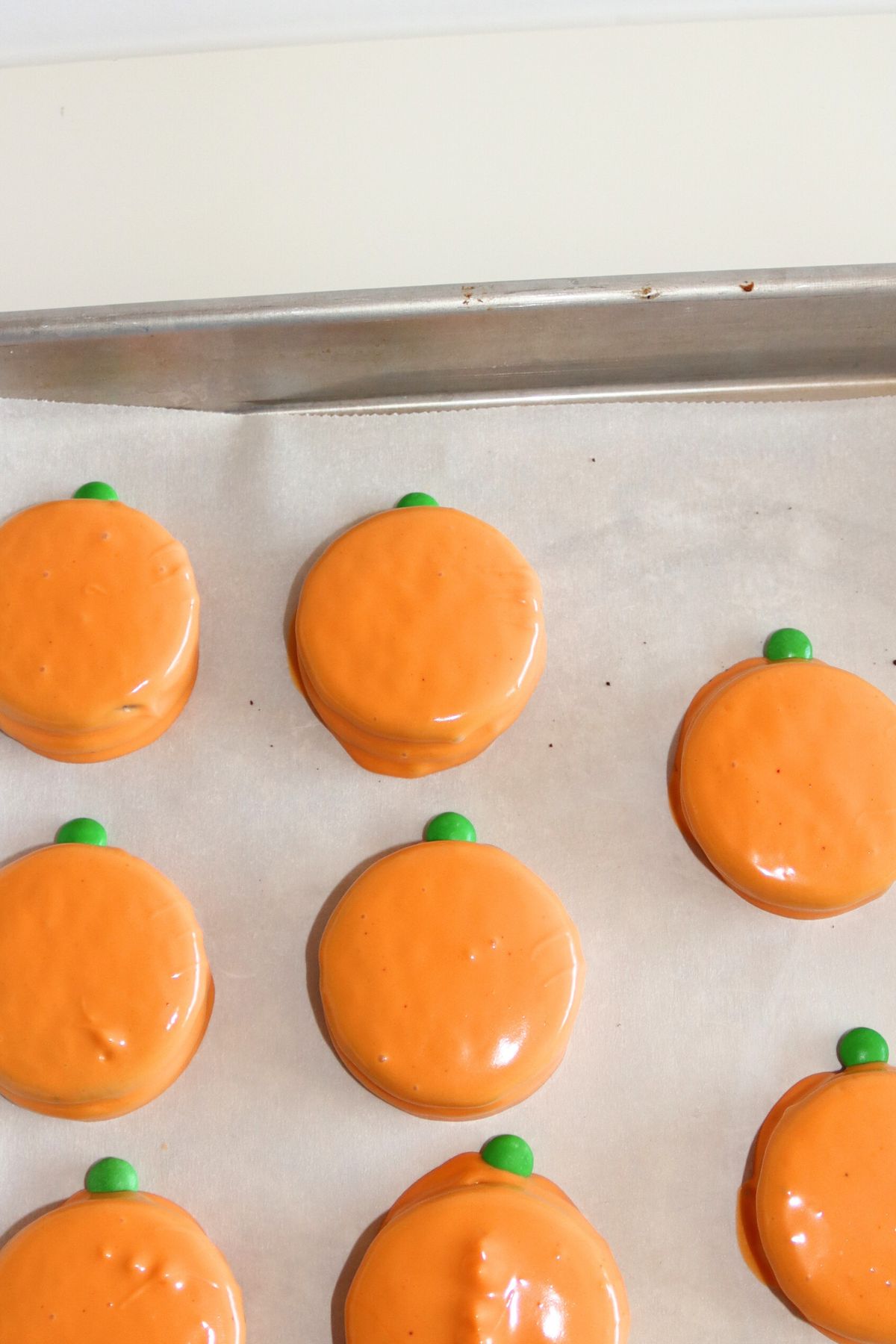 Oreos dipped in melted orange candy wafers.