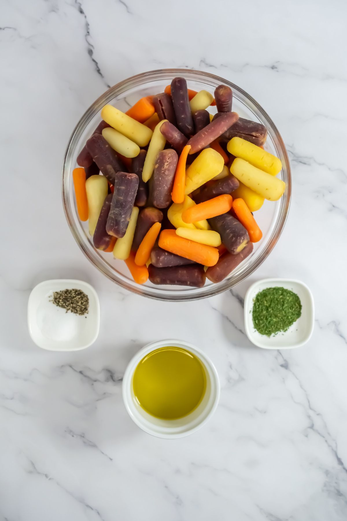 Roasted carrots ingredients on a marble counter.