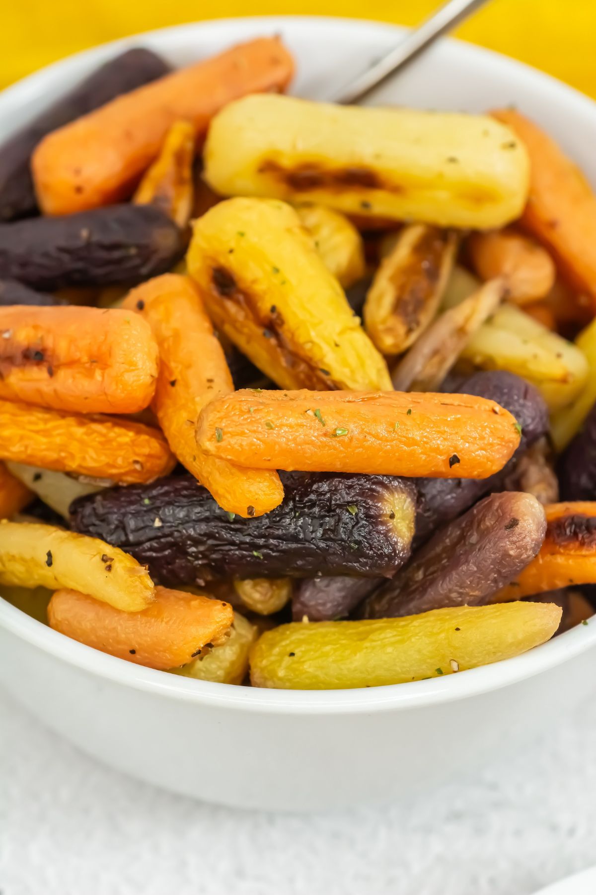 Roasted carrots in a white bowl.