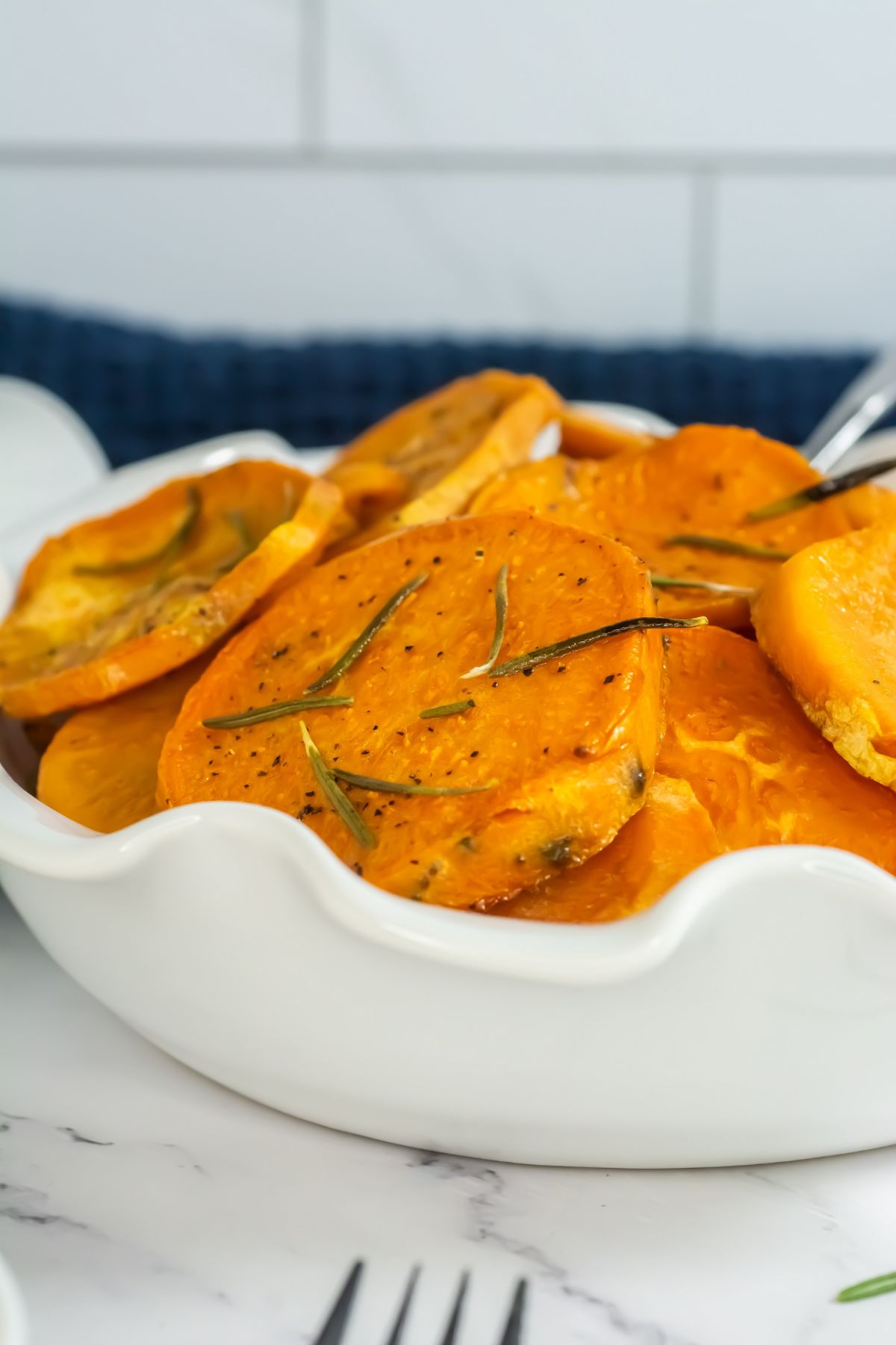 Sliced sweet potatoes in a white bowl.