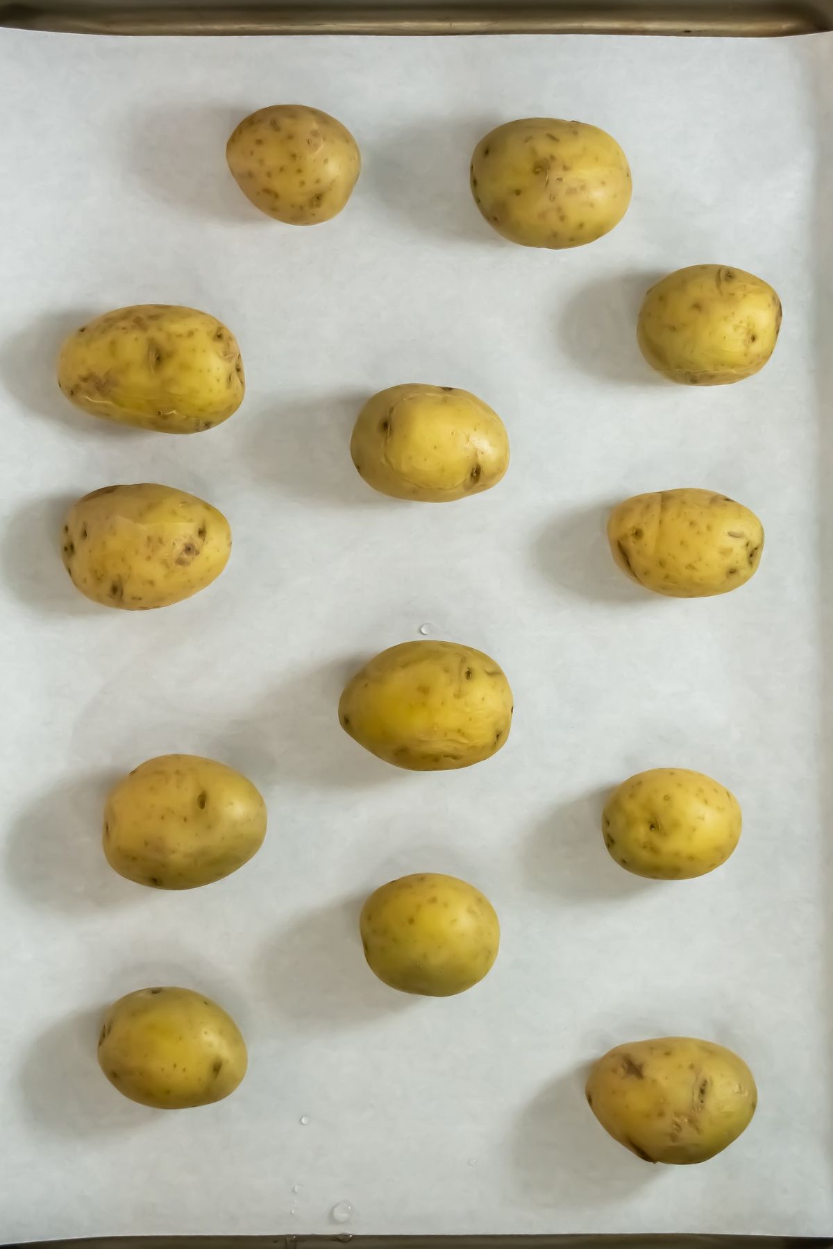 Cooked potatoes on baking sheet.