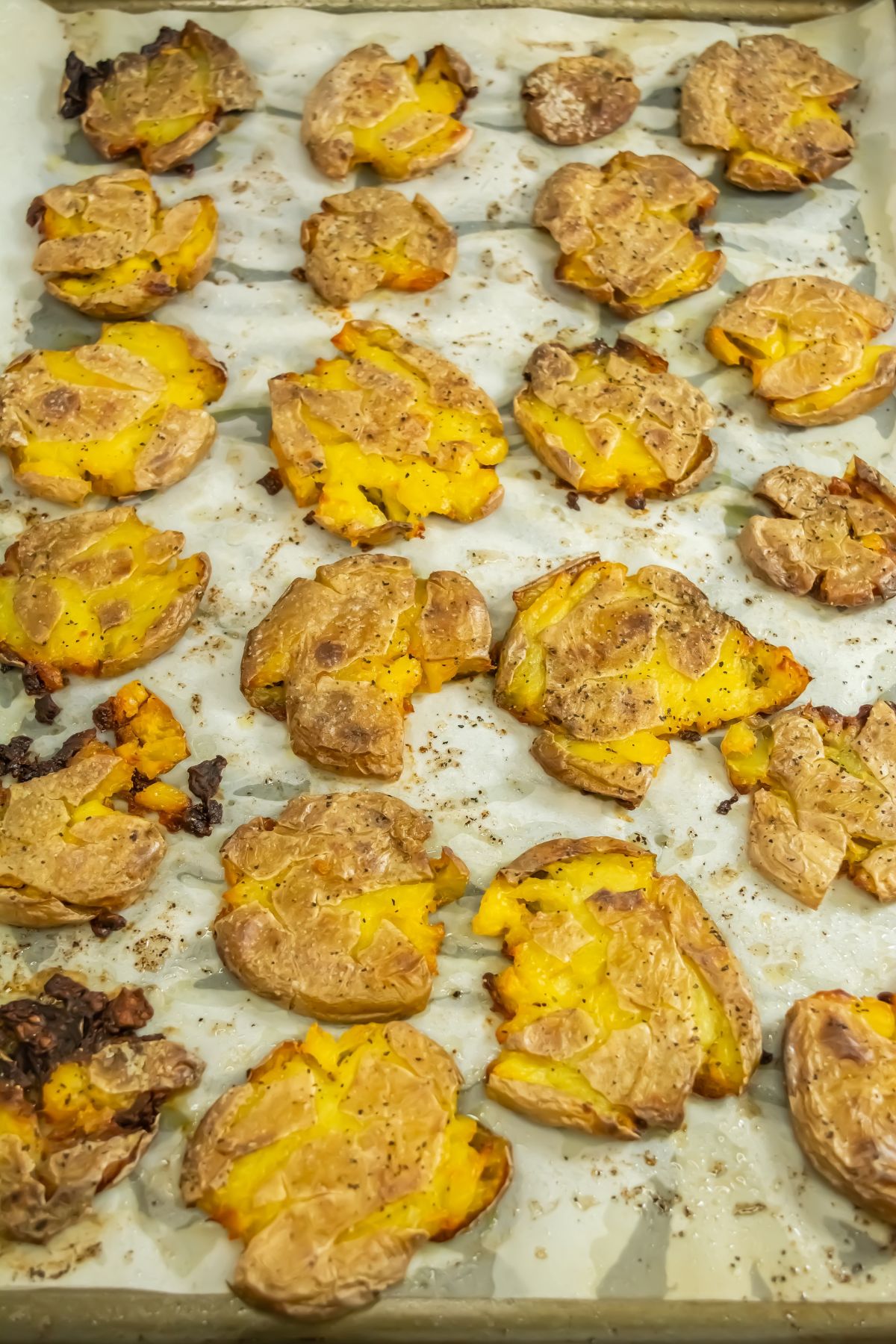 Smashed potatoes on a baking sheet.