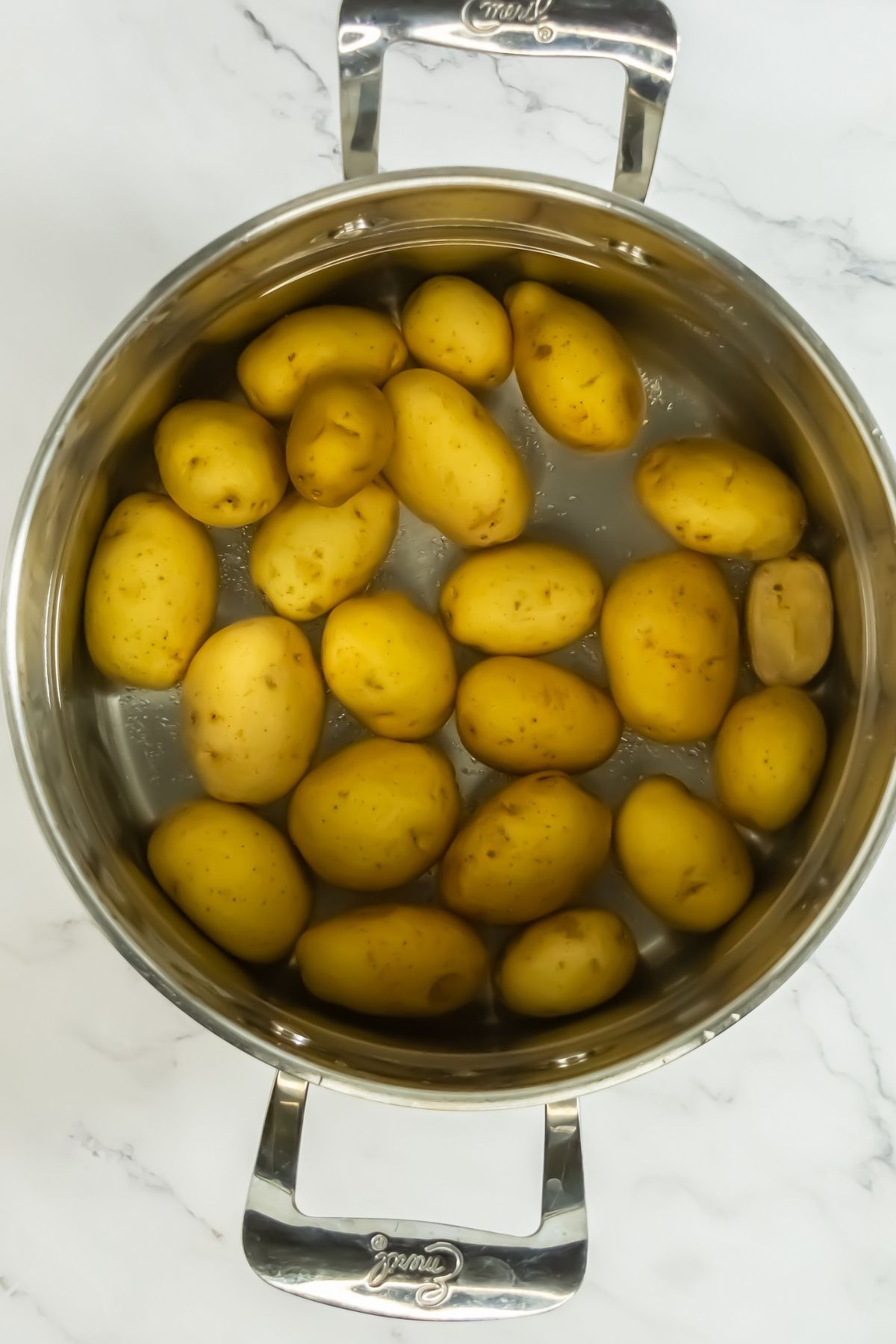 Cooking potatoes in pot.