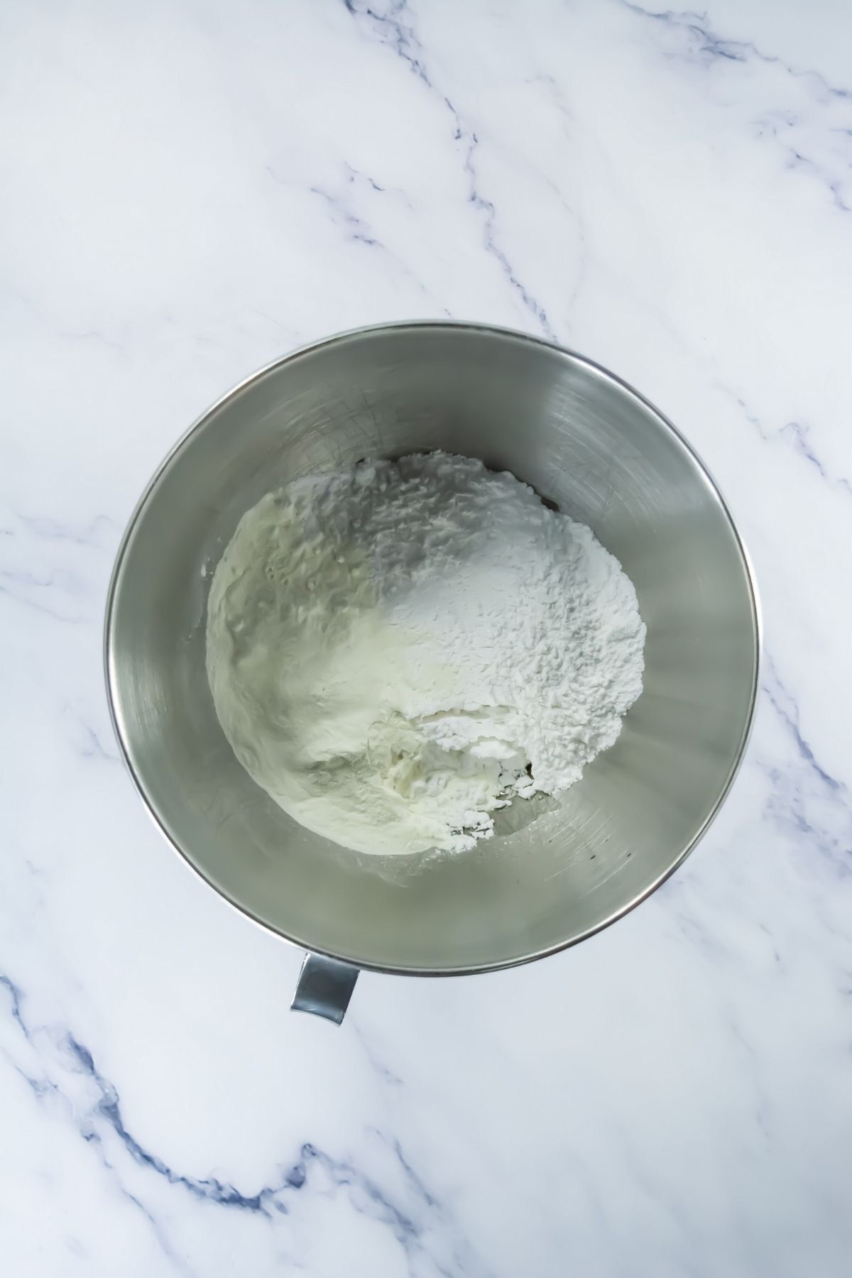 Sugar and whipped butter in a bowl.