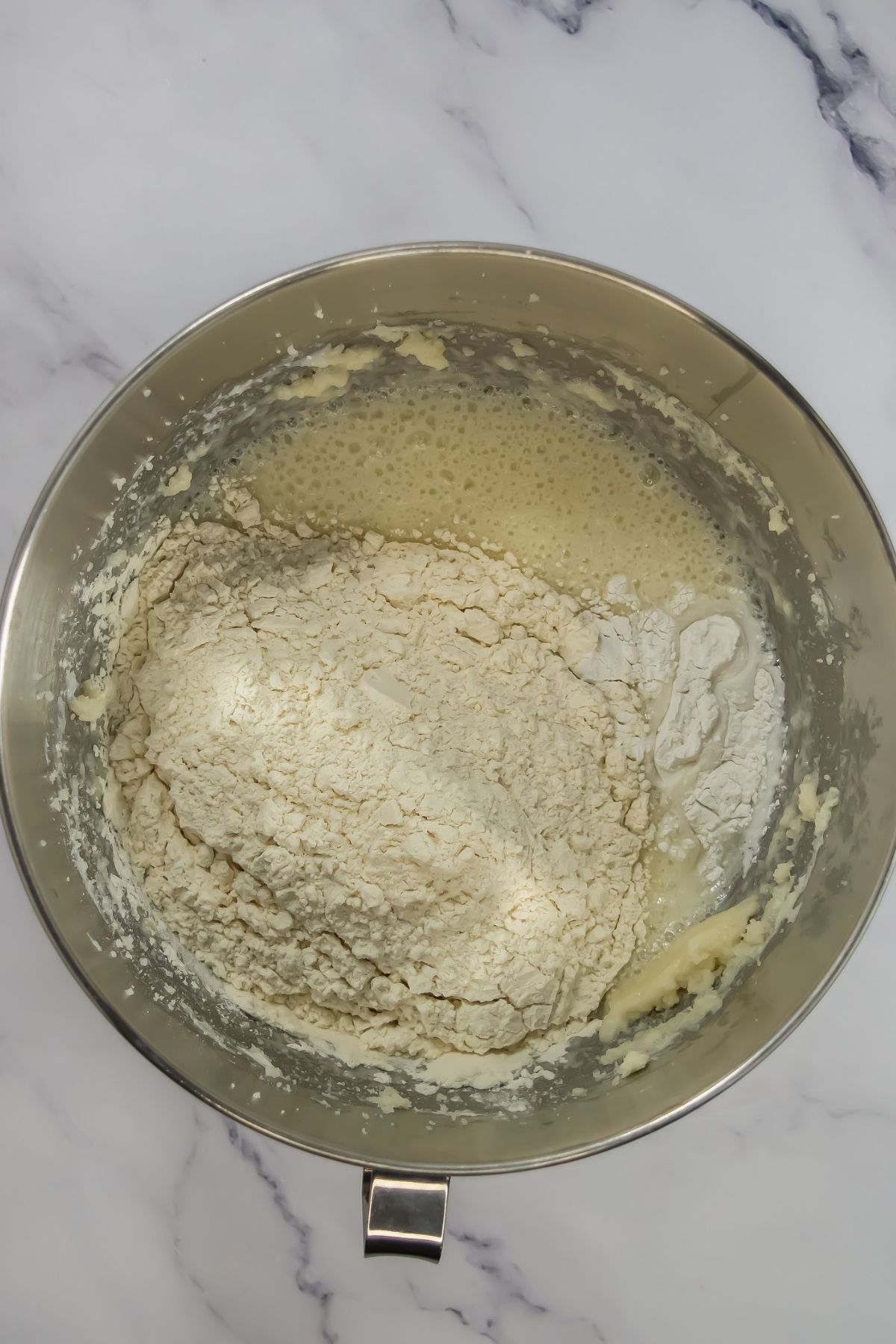 Adding dry ingredients to batter.