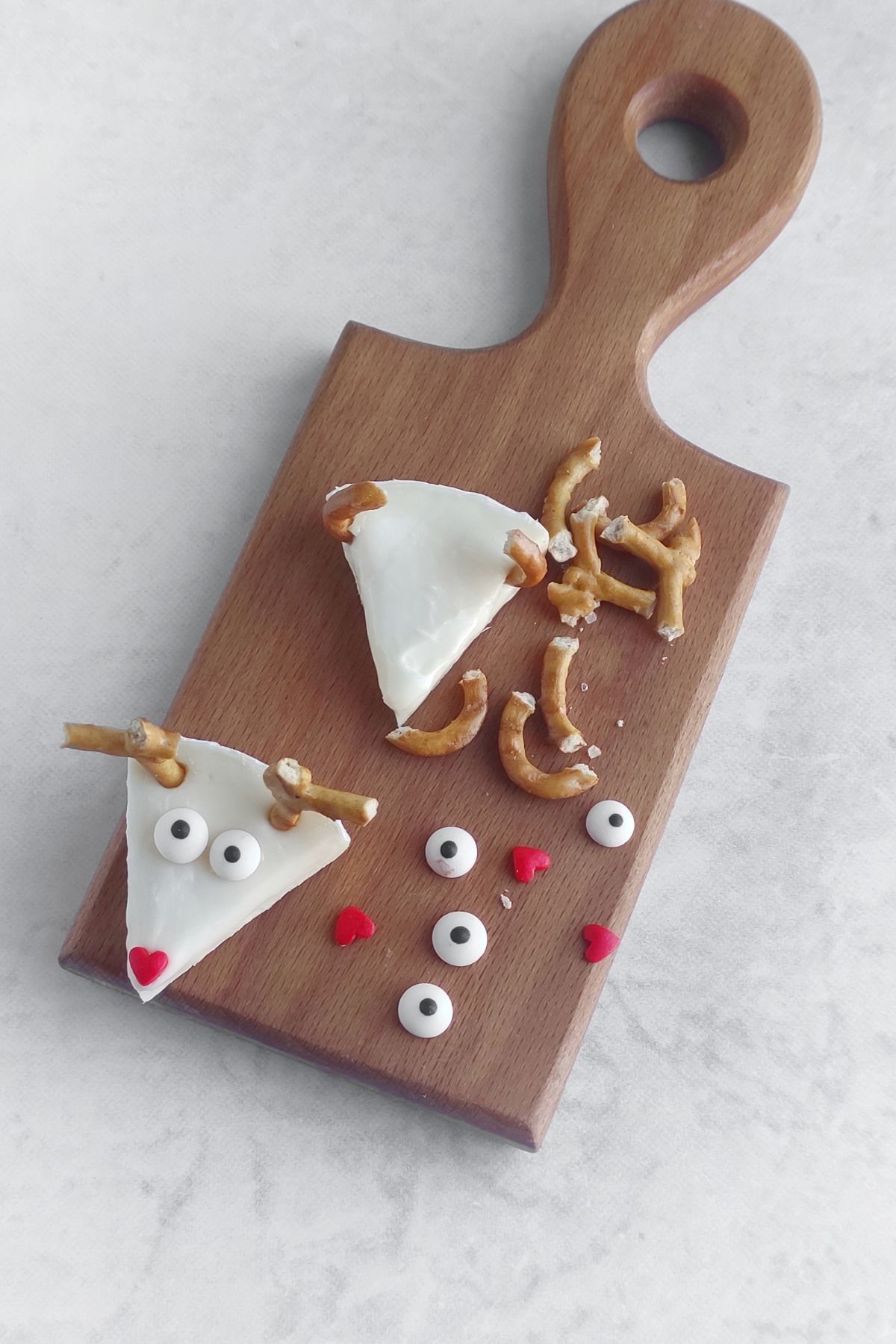Making reindeer brie bites.