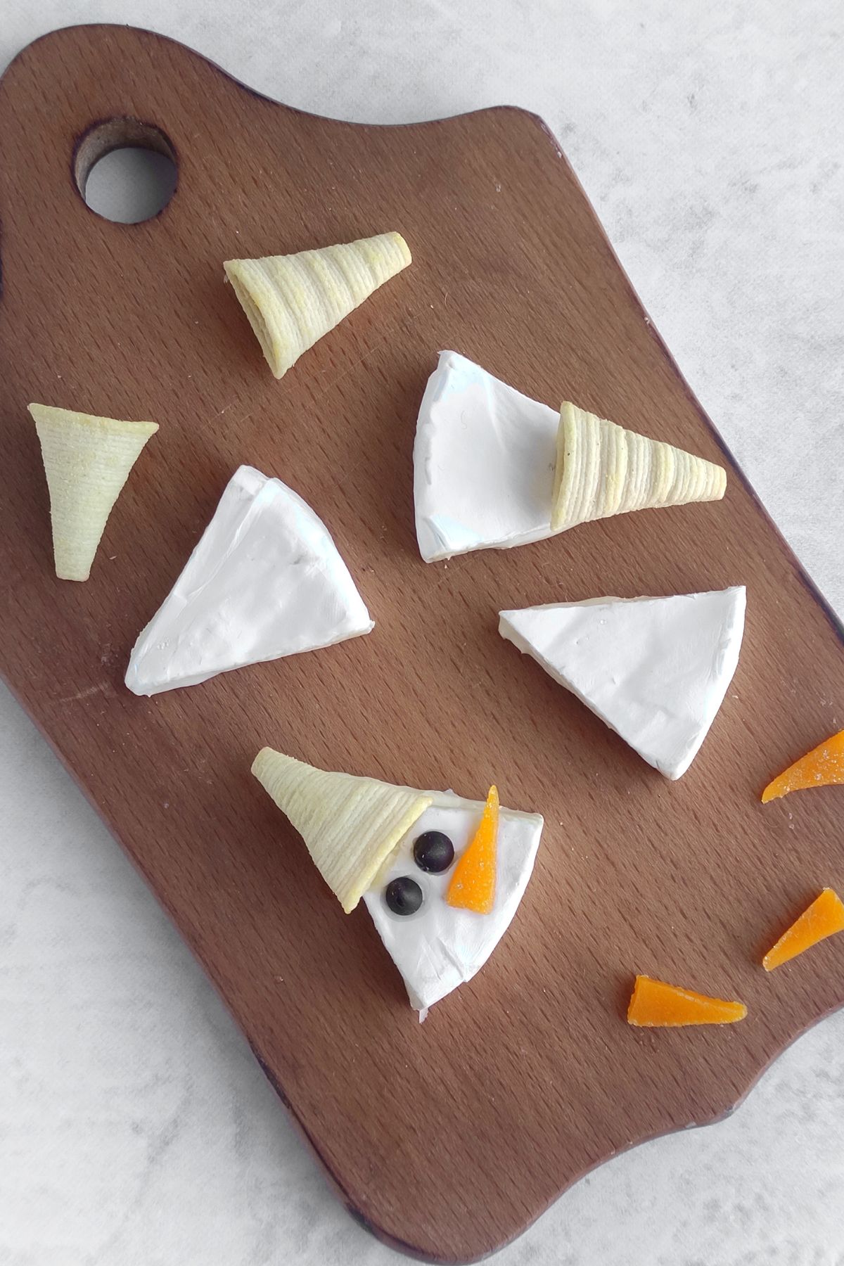 Making snowman brie bites.