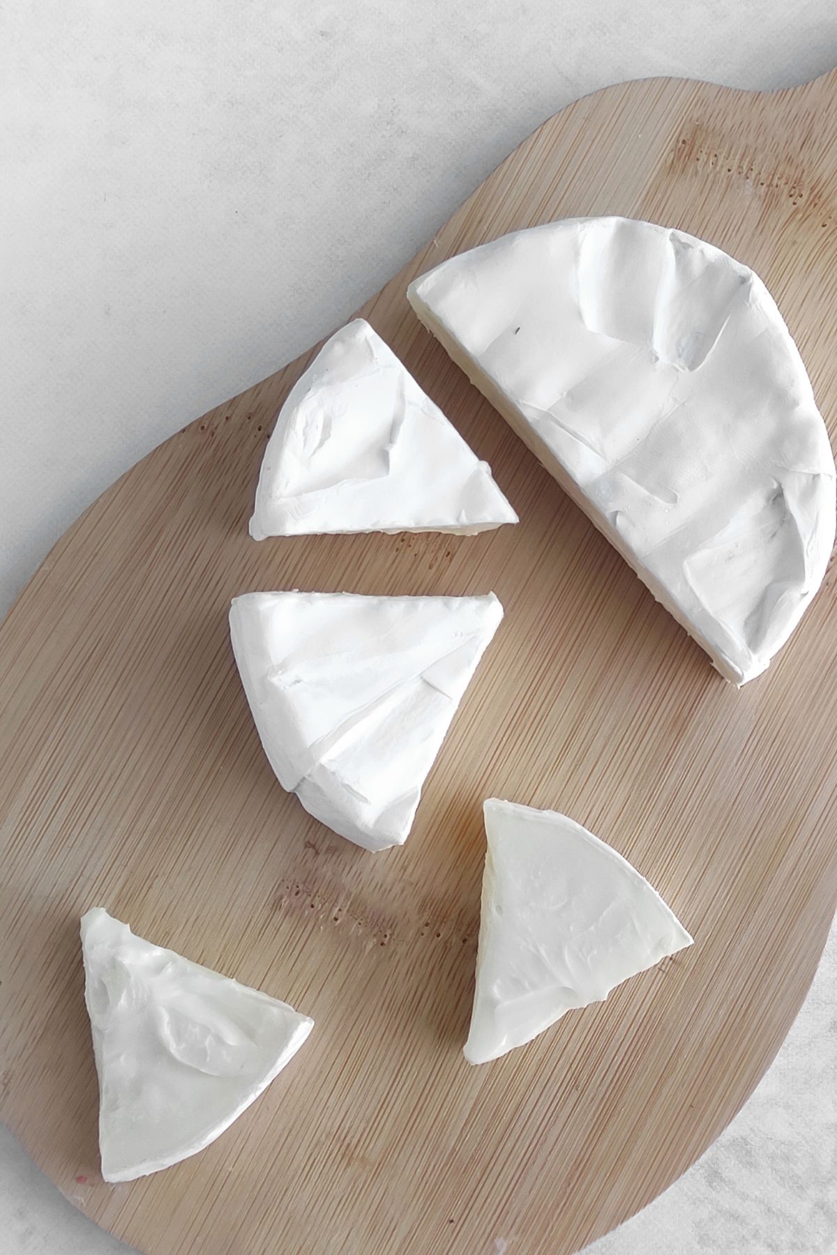 Cutting brie into triangles.