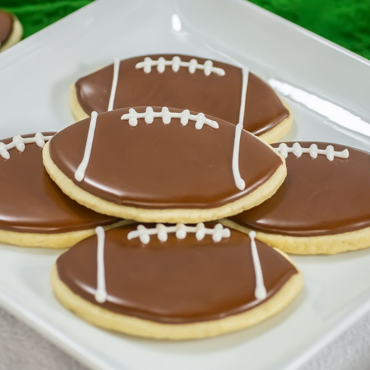 Football sugar cookies on a plate.