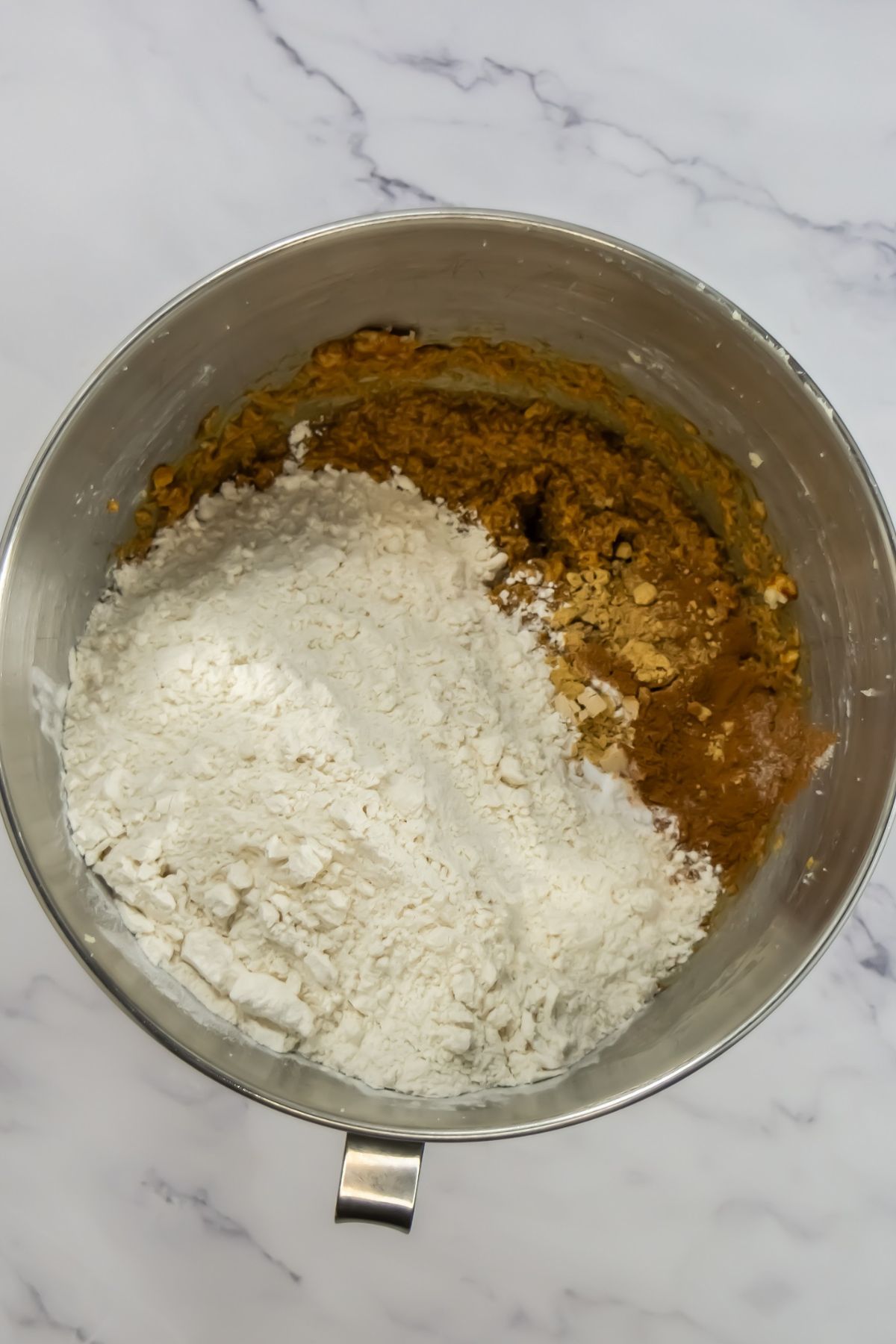 Adding dry ingredients to dough.