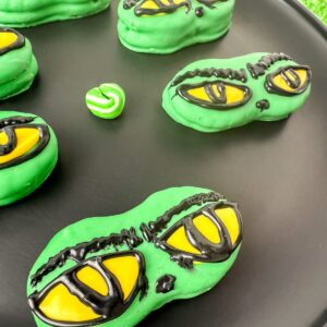 Grinch nutter butters on a black plate.