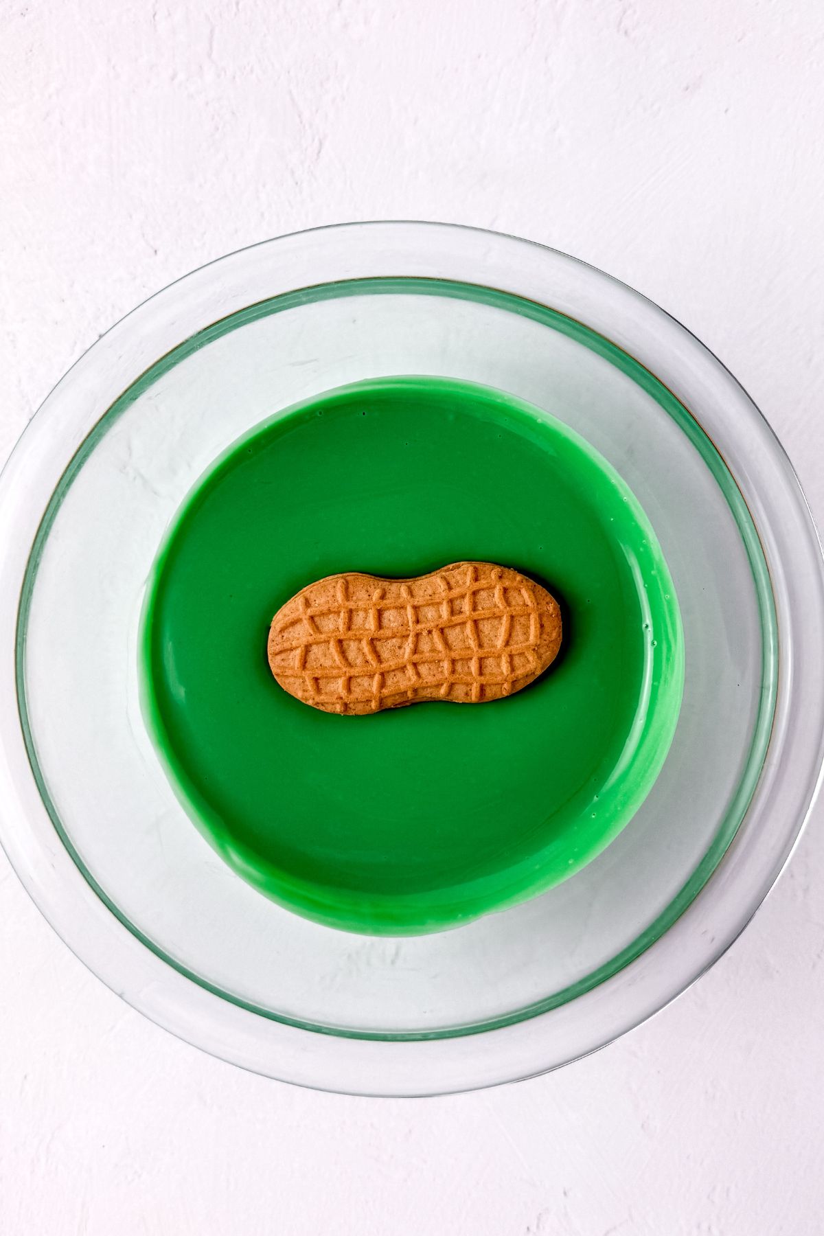 Dipping nutter butter in green melted candy melts.
