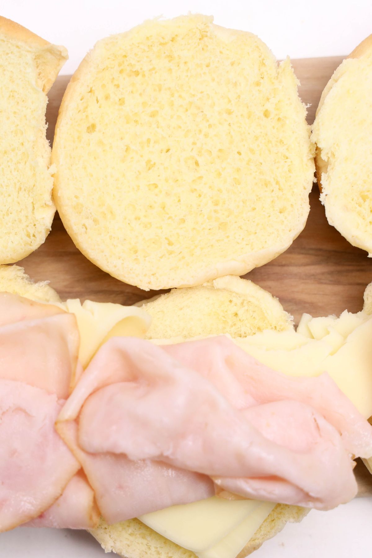 Adding turkey and cheese to slider.