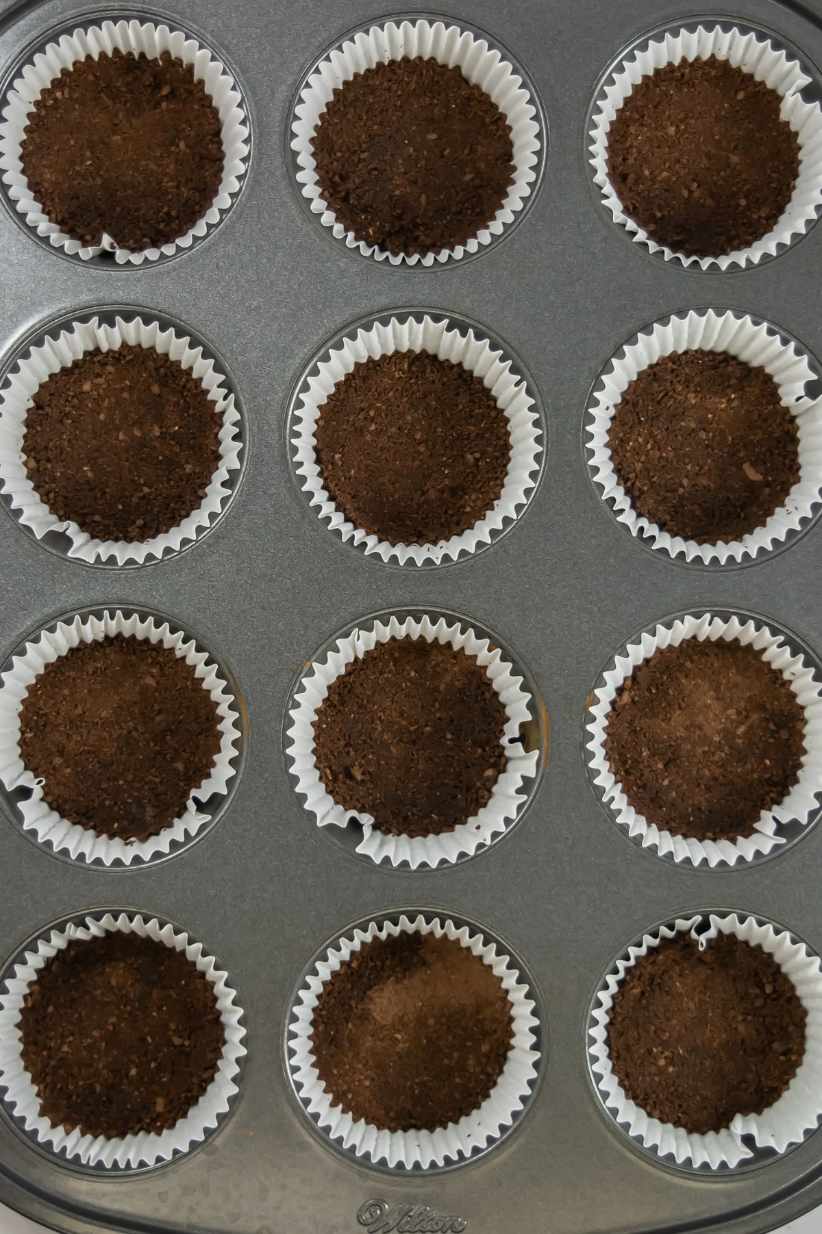 Chocolate crusts in muffin tins.