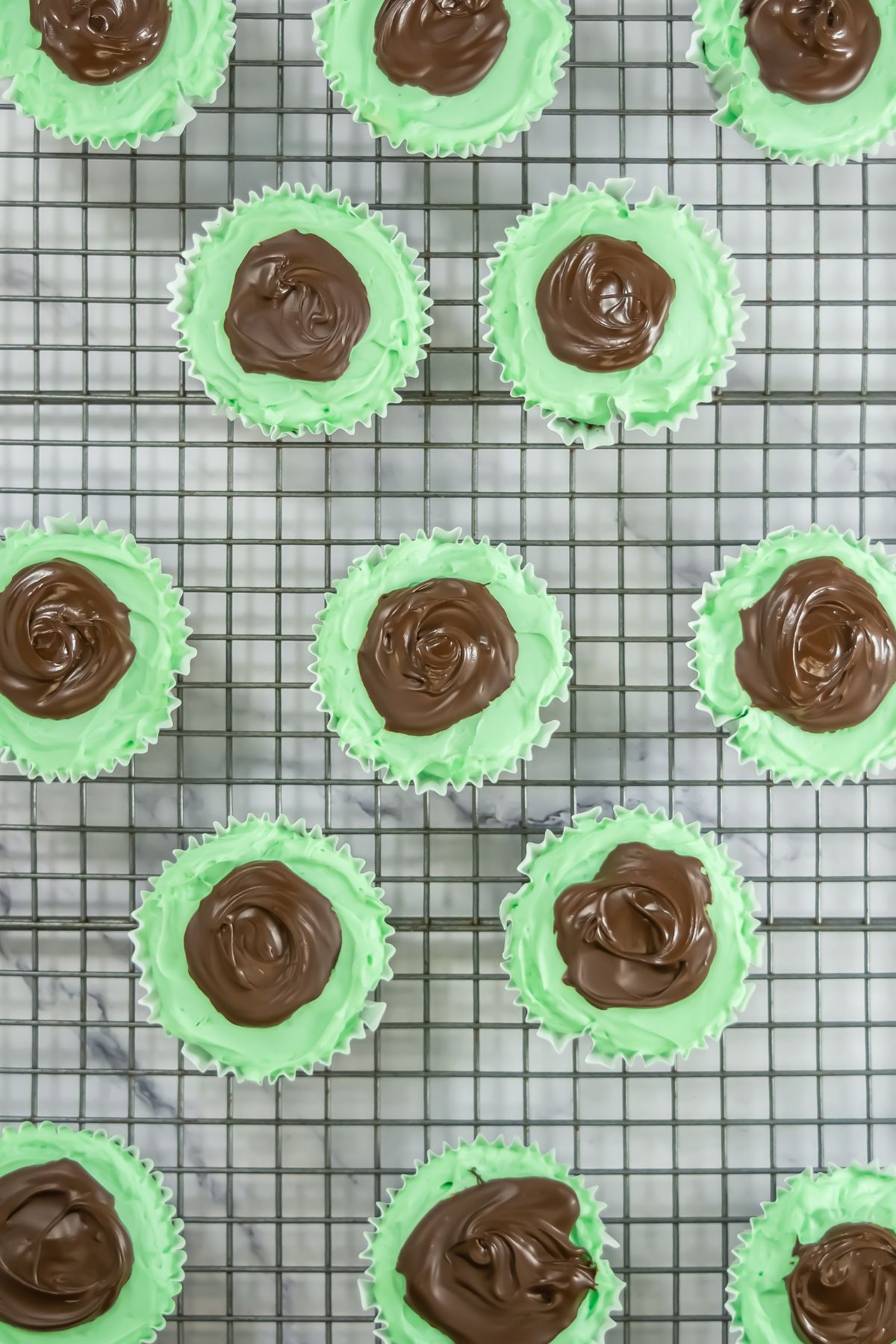 Andes mint cheesecakes on a cooling rack.