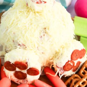 Bunny but cheeseball next to carrots and pretzels.