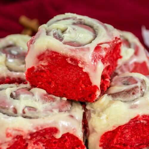 Red velvet cinnamon rolls in a stack.