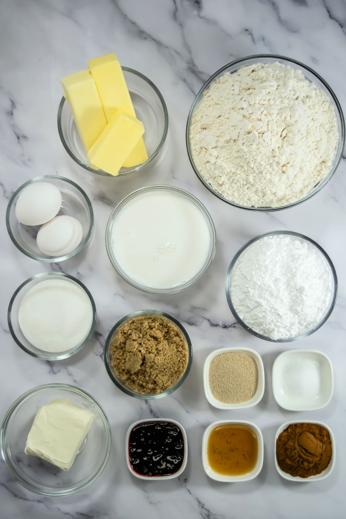 Red Velvet Cinnamon roll ingredients on a marble counter.