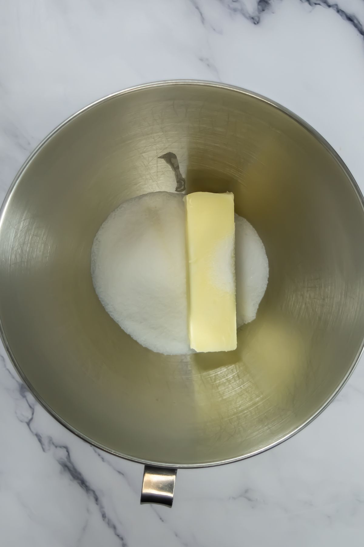 Butter and sugar in a bowl.