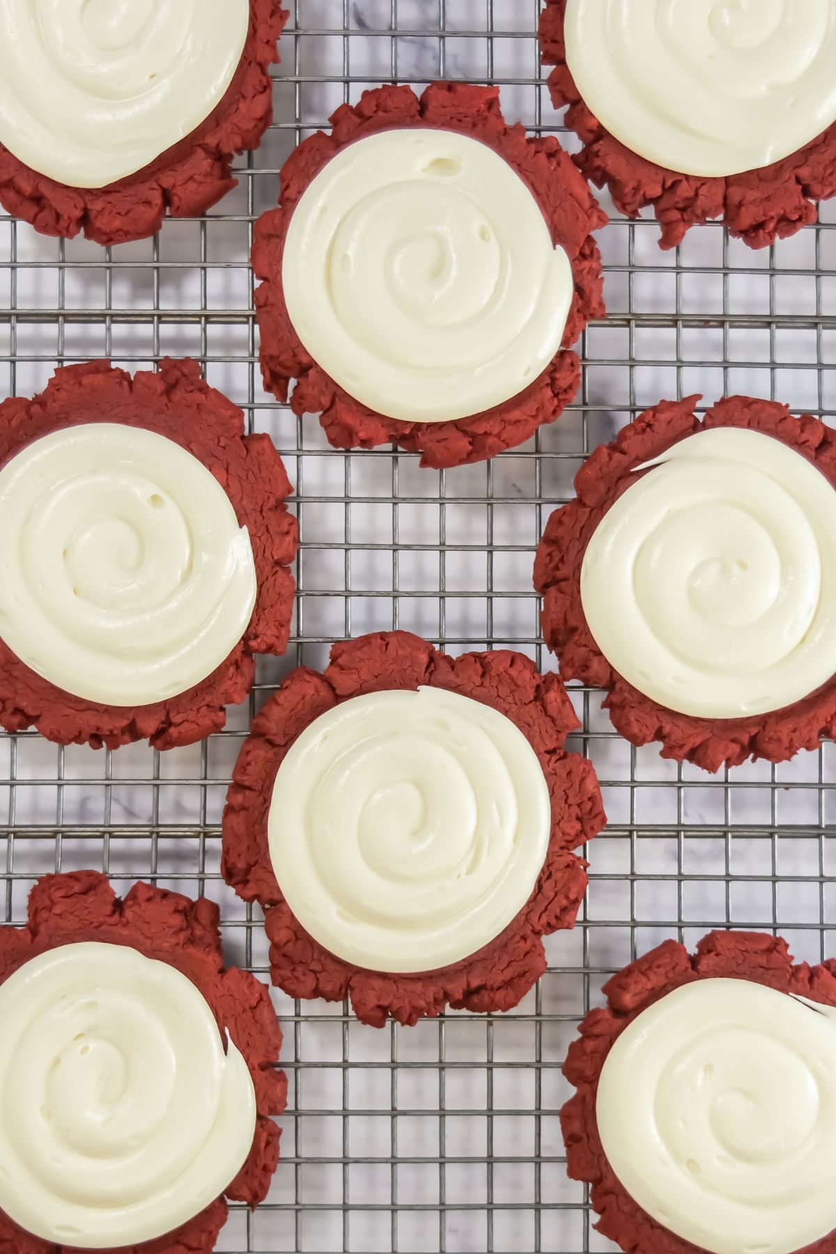 Red velvet cookies on a cooling rack.